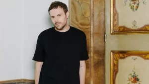 "Image depicting a dramatic scene with a spotlight on an empty designer's chair at Gucci, symbolizing the recent departure of Creative Director Sabato De Sarno.